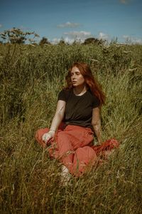 Young woman sitting on field