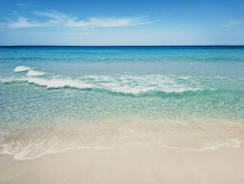 Turquoise water and golden beach near alimini lakes, salento, puglia, italy