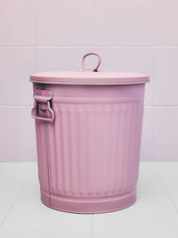 Close-up of metallic container on tiled floor against wall at home