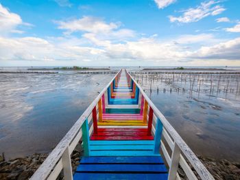 View of empty bridge over sea against sky. rainbow bridge and seaside bridge, bright colors.