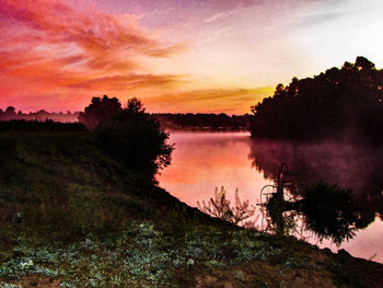 Scenic view of lake against sky during sunset