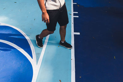 Low section of man skateboarding in swimming pool