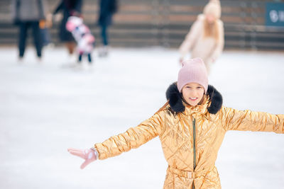 Portrait of young woman standing on snow