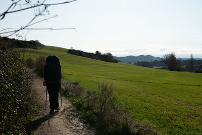 A young girl is walking on the camino de santiago on a path near uterga.