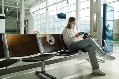 Side view of woman using mobile phone