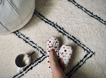 Low section of person wearing shoes on carpet