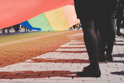 Low section of people walking on road