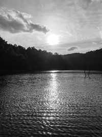 Scenic view of lake against cloudy sky