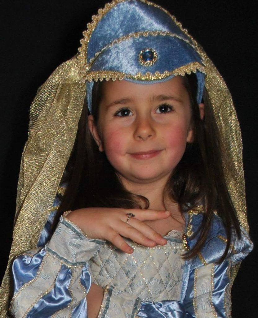 portrait, looking at camera, child, one person, black background, children only, waist up, childhood, girls, one girl only, crown, people, night, religion, smiling, real people, close-up, period costume