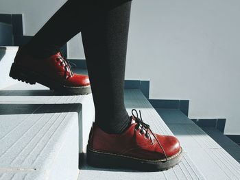 Low section of woman walking on steps