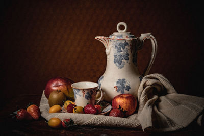 Close-up of fruits on table against black background