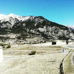 Scenic view of snow field against clear blue sky