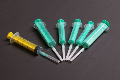 Close-up of syringe on black background