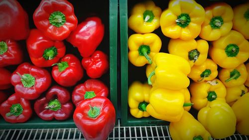 High angle view of red and yellow bell peppers at market
