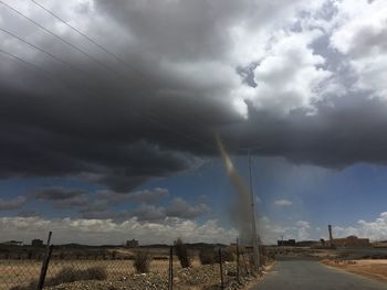 Low angle view of storm clouds over landscape