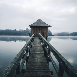 Pier over lake against sky