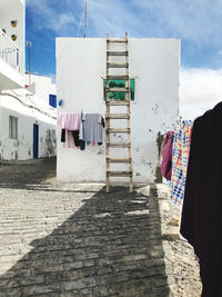 Clothes drying against buildings in city