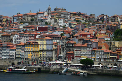 Sailboats in town by buildings in city