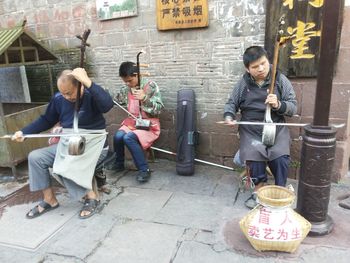 Full length of a young couple sitting outdoors