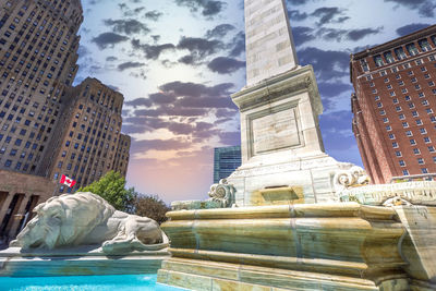 Statue of buildings against cloudy sky