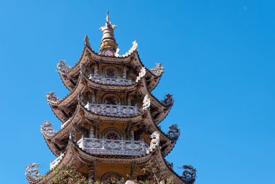 Low angle view of temple against clear blue sky