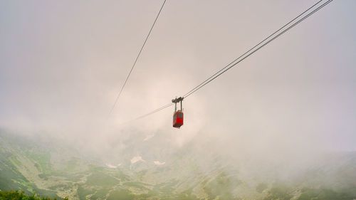 Overhead cable car against sky during winter