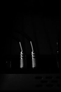 Close-up of metal grate against black background