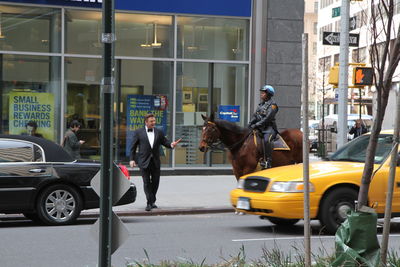 People riding motorcycle on street in city