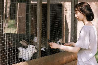 Side view of woman in cage