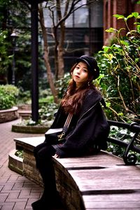 Portrait of woman sitting on bench