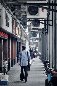 Rear view of man walking on street