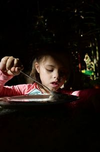 Close-up of girl eating at home