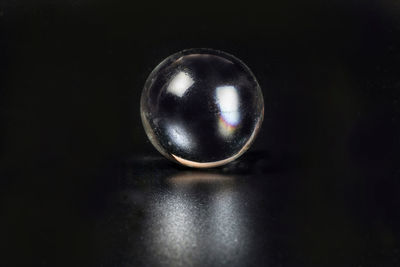 Close-up of crystal ball on black background