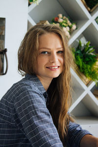 Portrait of smiling woman at home