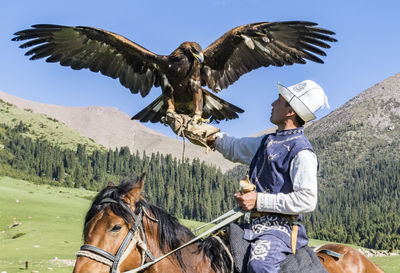Man riding flying bird