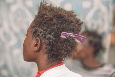 Close-up of boy with comb in hair