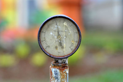 Close-up of damaged gauge against blurred background