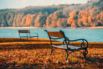 Empty chairs against sky