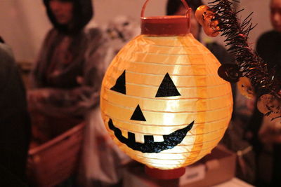 Close-up of jack o lantern shape illuminated lamp at home