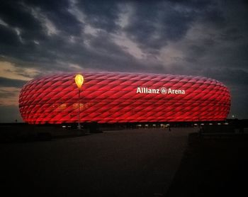 Low angle view of illuminated building against sky at dusk