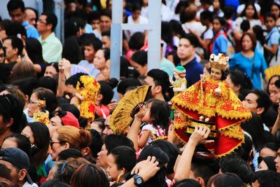 High angle view of crowd carrying child jesus during religious festival 