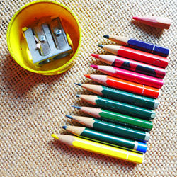 High angle view of colored pencils and sharpener on table