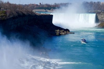 Scenic view of waterfall against sky