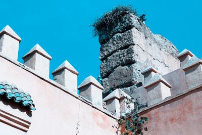 Low angle view of old building against clear blue sky