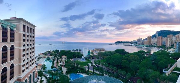 High angle view of buildings by sea against sky