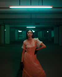 Full length of woman standing in illuminated building