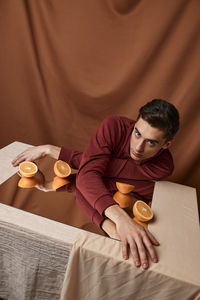 Portrait of man reflecting in mirror on table