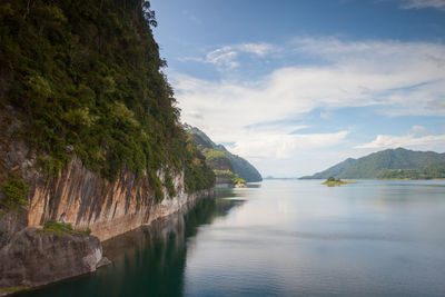 Scenic view of sea and mountains against sky