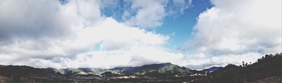 Scenic view of mountains against cloudy sky