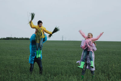 Full length of girl running on field